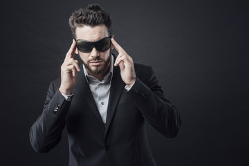 Elegant man adjusting sunglasses