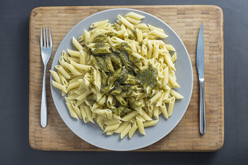 Tasty italian pasta green pesto sauce