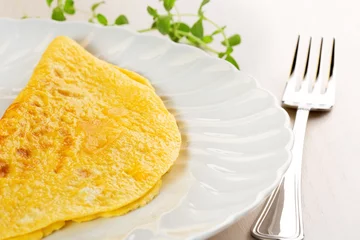 Foto op Aluminium close up of omelette and fork on table © Paulista