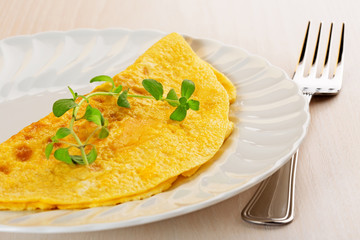 omelette garnished with a twig of marjoram