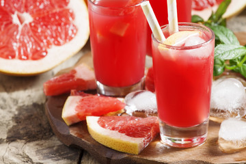 Red cocktail of fresh pink grapefruit, selective focus