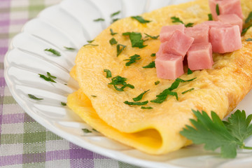 omelette garnished with diced ham and parsley