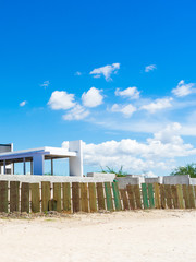 Seaside building on the beach with blue sky