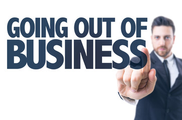 Business man pointing the text: Going Out Of Business