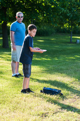 father and son playing disc golf