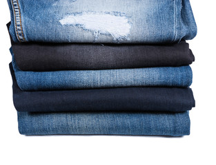 Stack of Folded Blue Jeans in Various Styles