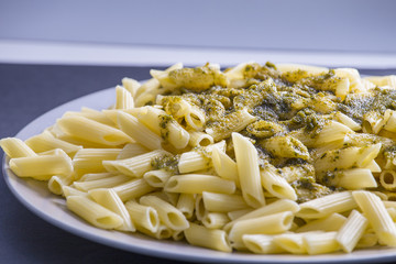 Italian pasta food close up on a grey dish and blue background