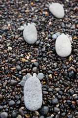 Footprint on wet sea pebbles