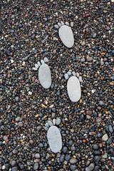 Footprint on wet sea pebbles