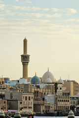Naklejka premium Bur Dubai and Al Juma Mosque at sunset