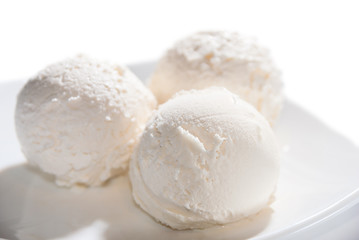 three balls of ice cream on a plate isolated