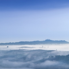 Fog covered mountains and forest in the morning.