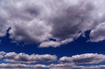 Fototapeta na wymiar Blue Sky with White and Grey Silvery Clouds
