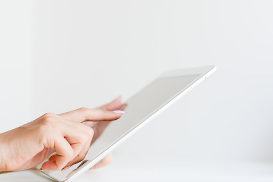 Woman hand browsing a digital tablet