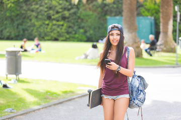 Portrait of a beautiful skater girl looking at smart phone © william87