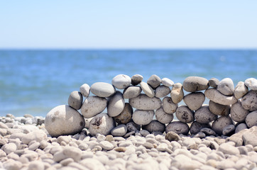 Stones stacked into a wall at the seaside
