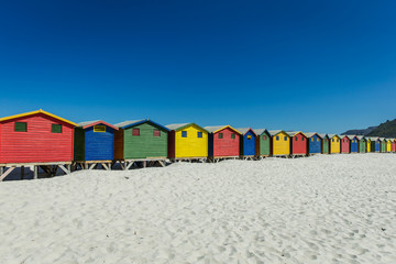 Obraz premium Colored Beach Houses in Muizenberg Cape Town, South Africa, beach, blue sky