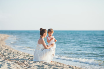 Family having fun on the beach collecting seashells