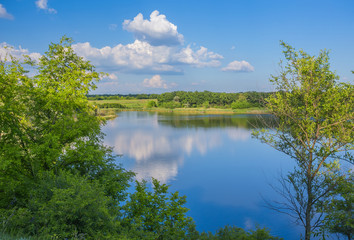 Calm beautiful rural landscape with a lake 