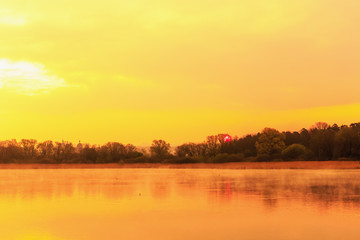 Fototapeta na wymiar Serene Sunrise at the Lake in Bavaria, Germany. Lovely warm spring morning