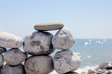 Small Flat Rock Balancing on Rock Beach Wall