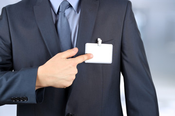 The business man showing a  Blank Badge