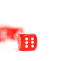 rolling red dice isolated on white