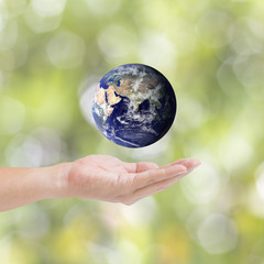 Human hands carrying global Earth. Environment concept. Elements