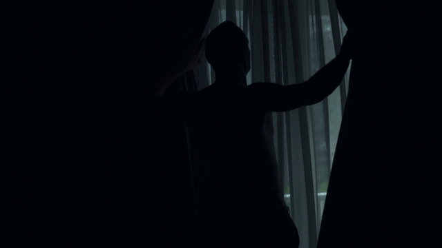Man unveil curtains in hotel room, view at cityscape, super slow motion, 240fps
