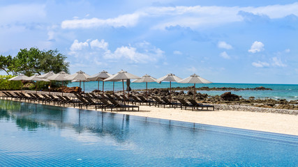 daybeds at poolside with sea view