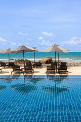 daybeds at poolside with sea view