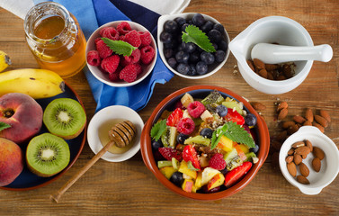 Healthy homemade fruit salad, fresh berries and fruits on   rust