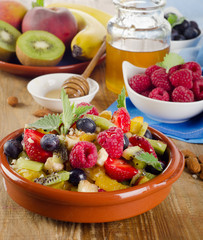 Healthy homemade fruit salad, fresh berries and fruits on a  old