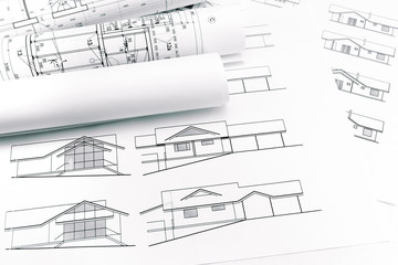 rolls of blueprints for house construction