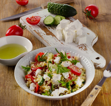 Gluten free  salad  with  feta on  wooden table.