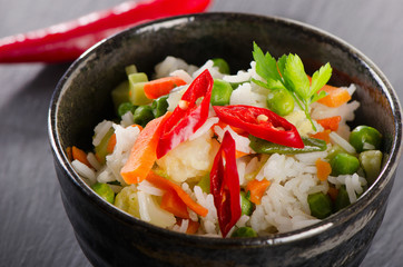 Rice and  vegetables on a black board.