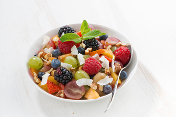 fruit salad in bowl on white wooden table