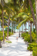 Woman walking on Paje beach, Zanzibar. - obrazy, fototapety, plakaty