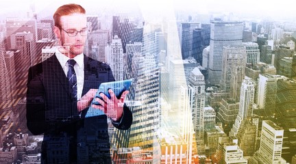 Fototapeta premium Composite image of unsmiling businessman using tablet pc