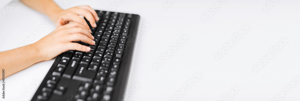 Wall mural student girls hands typing on keyboard