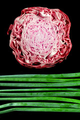 Obraz premium fresh wet onion greens and red cabbage sunset on meadow
