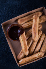 Street food latin churros with chocolate dip
