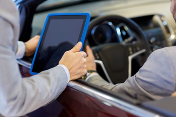 close up of men with tablet pc in car salon