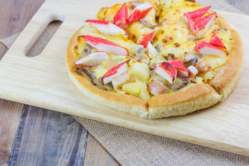 Homemade pizza on wooden table
