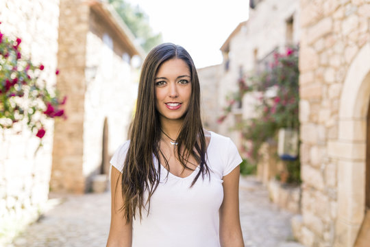 young attractive woman walking in a beautiful old town