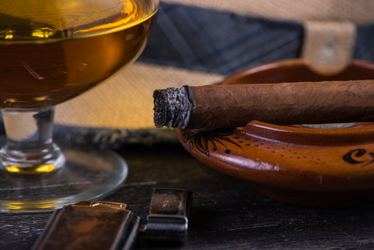 Cuban cigar,straw panama hat and lighter