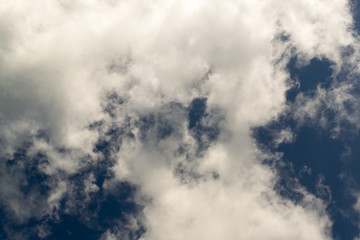 Wispy White Clouds Against Dark Blue Sky