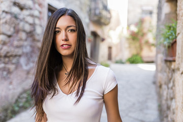 young attractive woman walking in a beautiful old town - 85145881