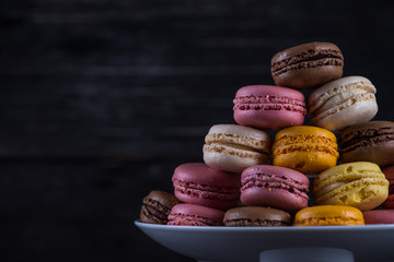 Stack of vibrant fresh macaroons on platter