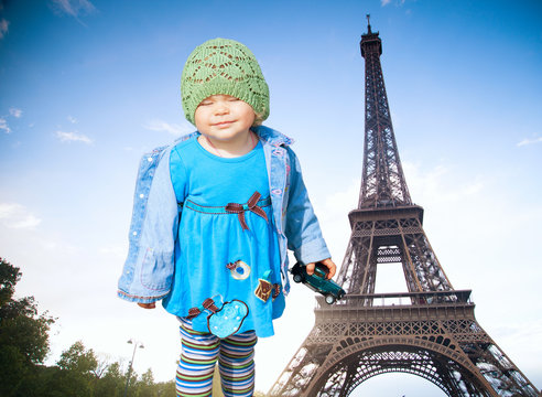 girl on the background of the Eiffel Tower. small French two yea
